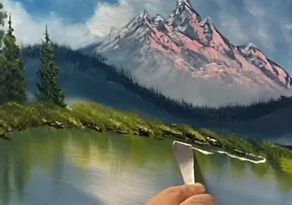 Mark Terrell demonstrating a Bob Ross snowy mountain lake oil painting with a palette knife